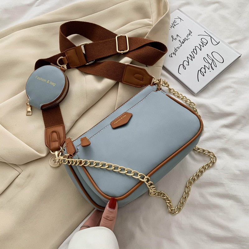 Blue handbag with a gold chain strap in an indoor setting sold at PeachyBeanz.