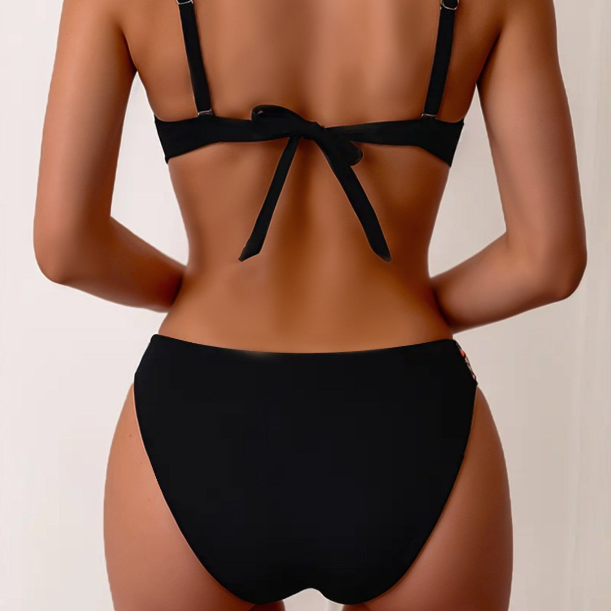 Beautiful Black two-piece bikini with colorful accented stitching to add a flare.