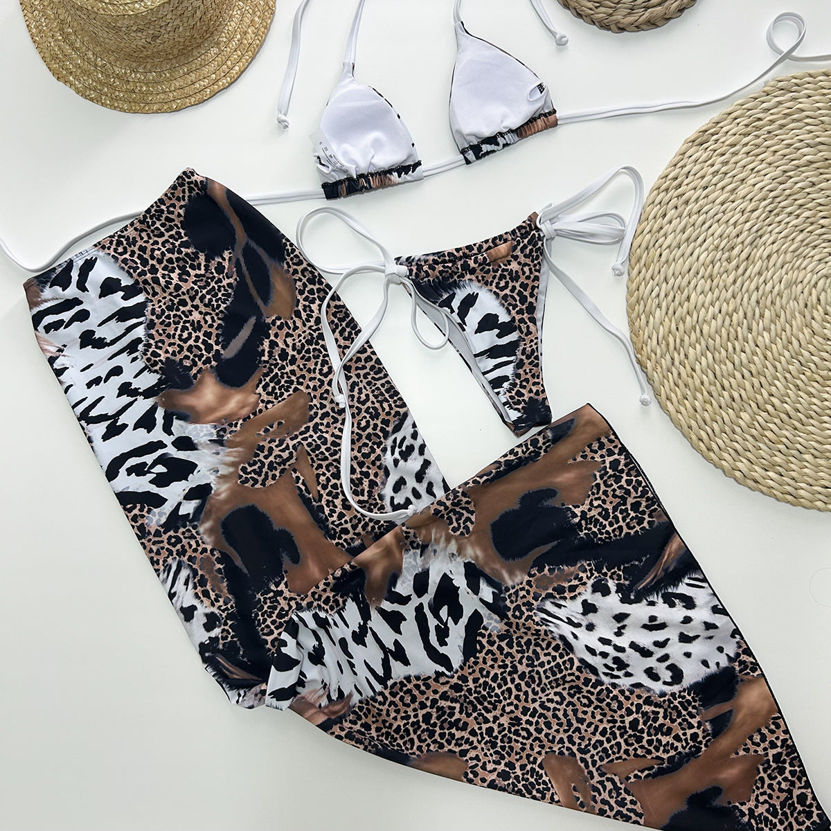 Female three‑piece leopard print bikini set featuring a padded, wire‑free nylon top with Lycra‑spandex lining, matching bottoms, and coordinating cover piece.