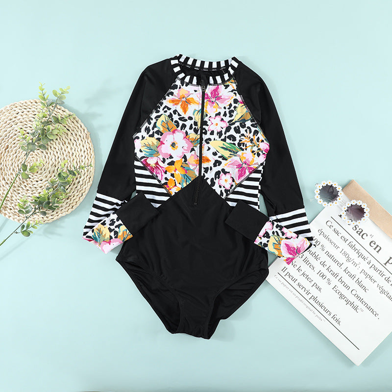 Close‑up of floral print and stretch fabric showing texture, stitch detail, and vibrant color contrast.