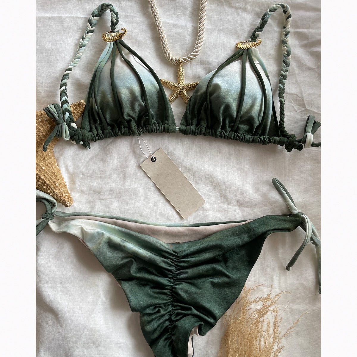 Green bikini set with gold accents on a white background