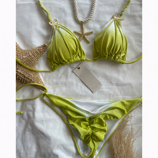 Green bikini set with gold accents on a white background