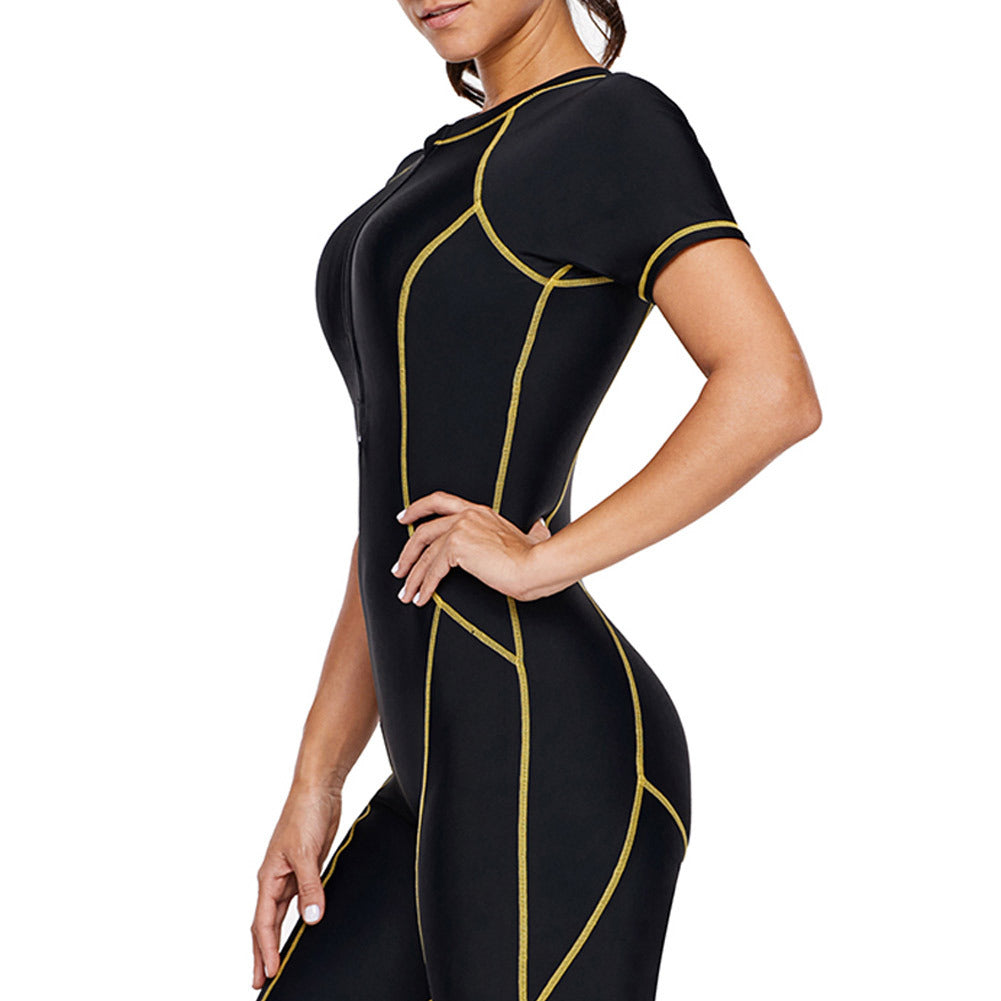 Model wearing a short‑sleeve surf snorkeling wetsuit with contrast panels and front zipper, posed against a plain backdrop.