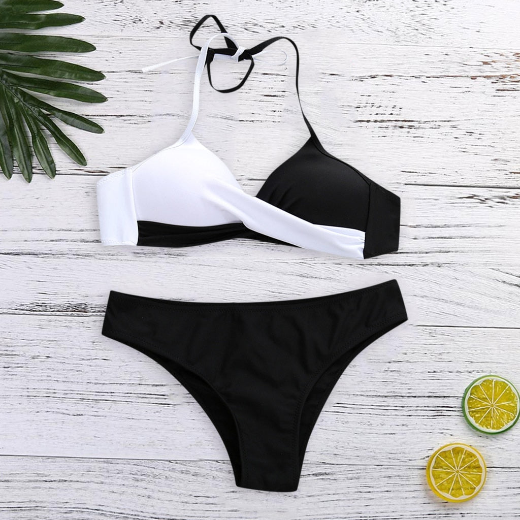 Two‑piece women’s bikini set featuring a padded push‑up top with spaghetti straps and a low‑waist patchwork bikini bottom, displayed in a flat lay on a neutral background.