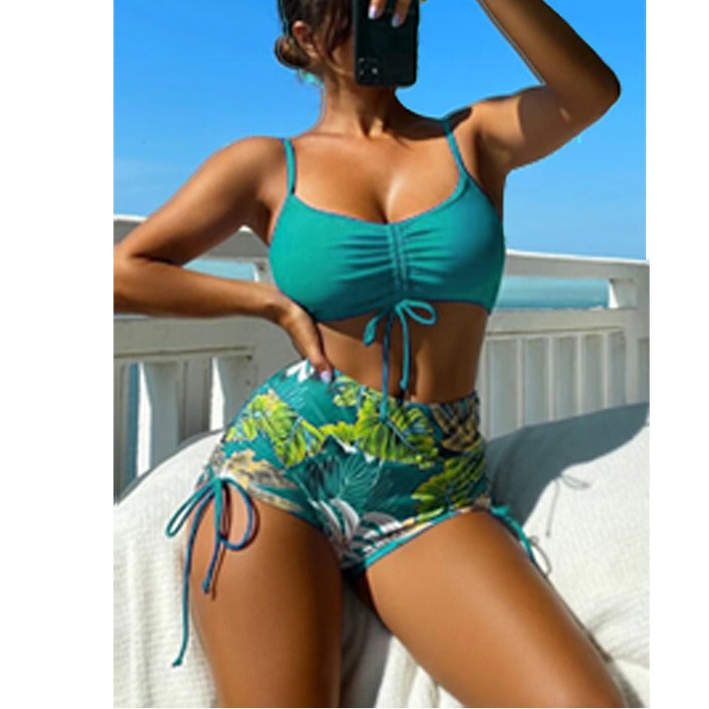Bra‑style swim top with matching shorts featuring adjustable side string ties; sporty, secure fit.