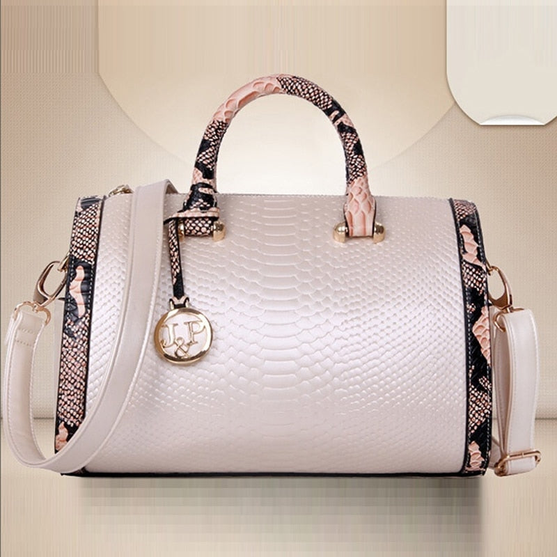Women’s luxury faux‑leather snakeskin crossbody handbag with top handle and shoulder strap.