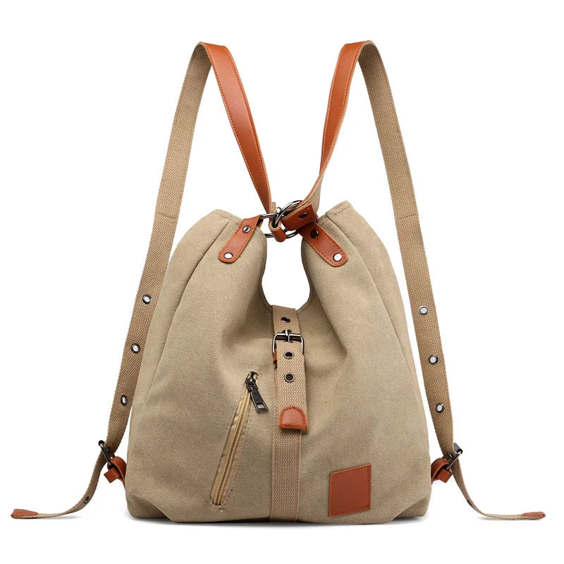 Women’s soft canvas backpack with zipper closure, top handle, and shoulder straps, featuring external pockets and a casual everyday design.