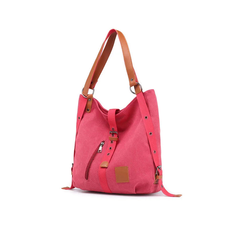 Women’s soft canvas backpack in pink with zipper closure, top handle, and shoulder straps, featuring external pockets and a casual everyday design.