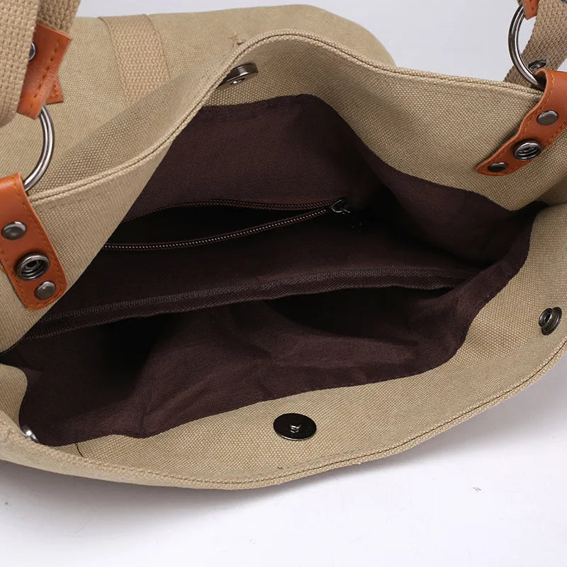 Women’s soft canvas backpack with zipper closure, top handle, and shoulder straps, featuring external pockets and a casual everyday design.