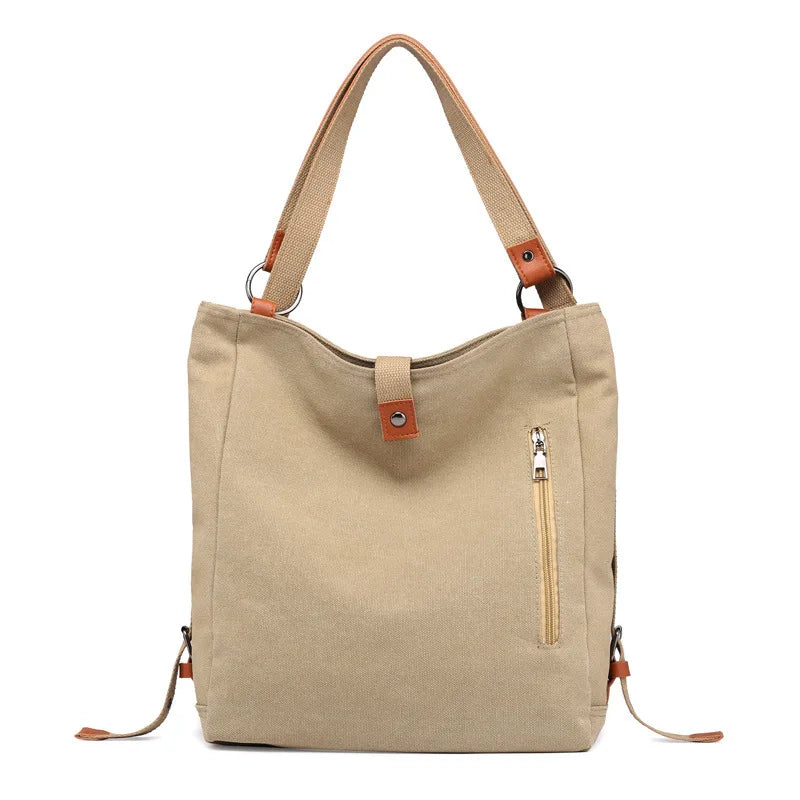 Women’s soft canvas backpack with zipper closure, top handle, and shoulder straps, featuring external pockets and a casual everyday design.