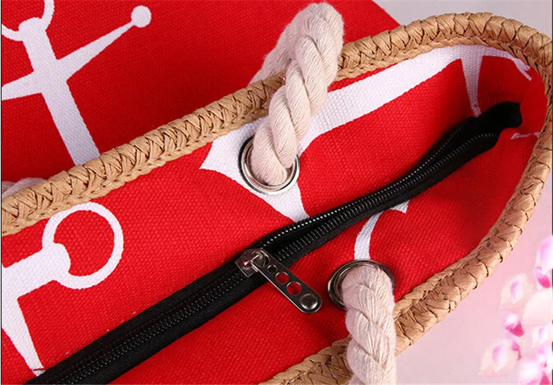 Red bag with white patterns and a black zipper, featuring a woven handle.