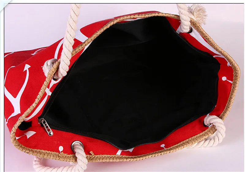 Red bag with white patterns and rope handles on a light pink background