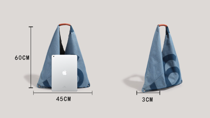 A blue fabric shoulder bag with a red handle is shown in two views on a light gray background, with measurement lines and labels indicating dimensions of 60 cm height, 45 cm width, and 3 cm depth. An iPad is placed in front of one bag for scale.
