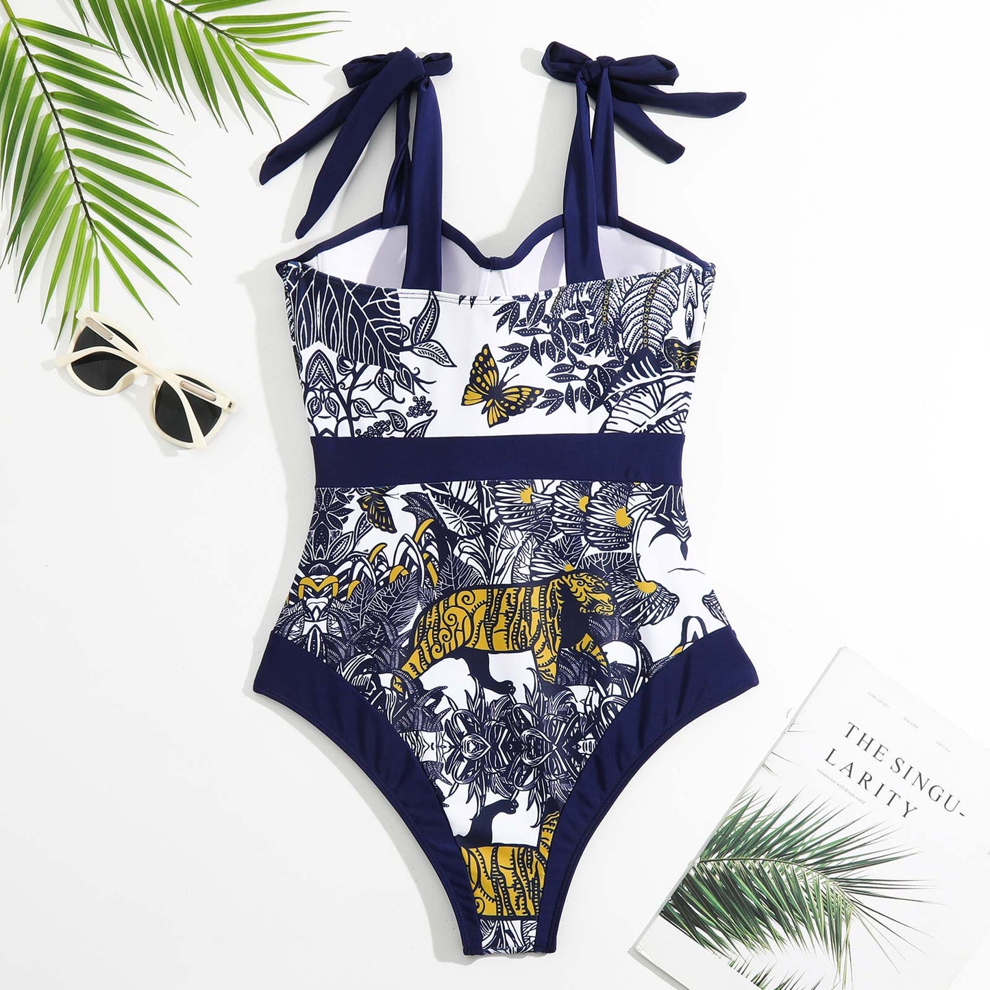 One-piece swimsuit with tropical pattern on a white background