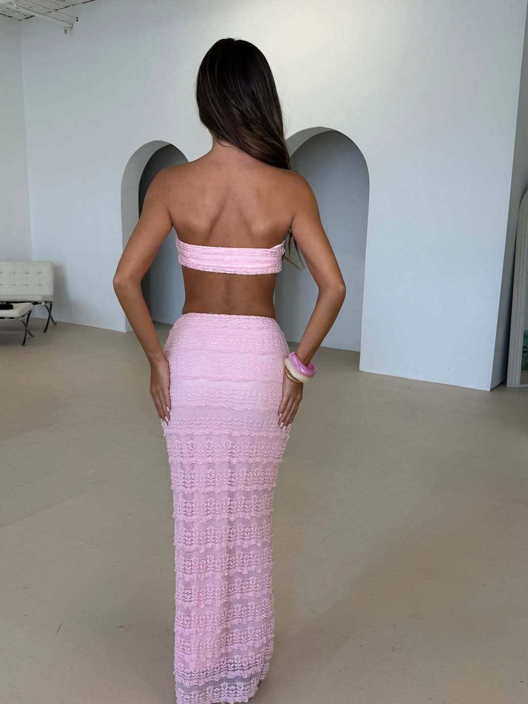 Lace jacquard seaside two‑piece set featuring a cropped lace top with scalloped hem and coordinating skirt; lightweight, breathable fabric with delicate floral jacquard.