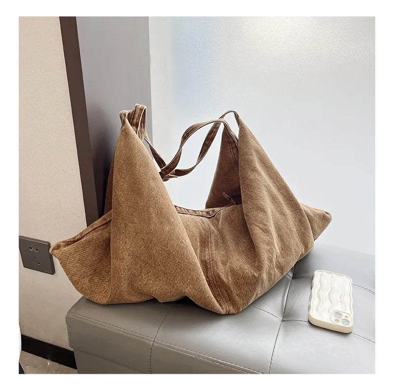 Brown tote bag on a gray surface with a blurred background