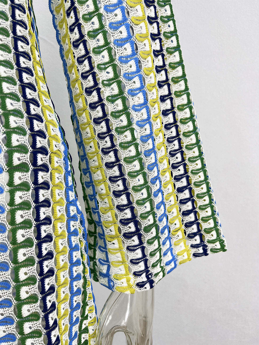 Colorful woven fabric with a geometric pattern on a white background