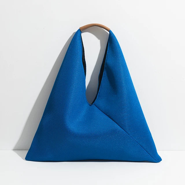 Blue handbag with a handle on a white background