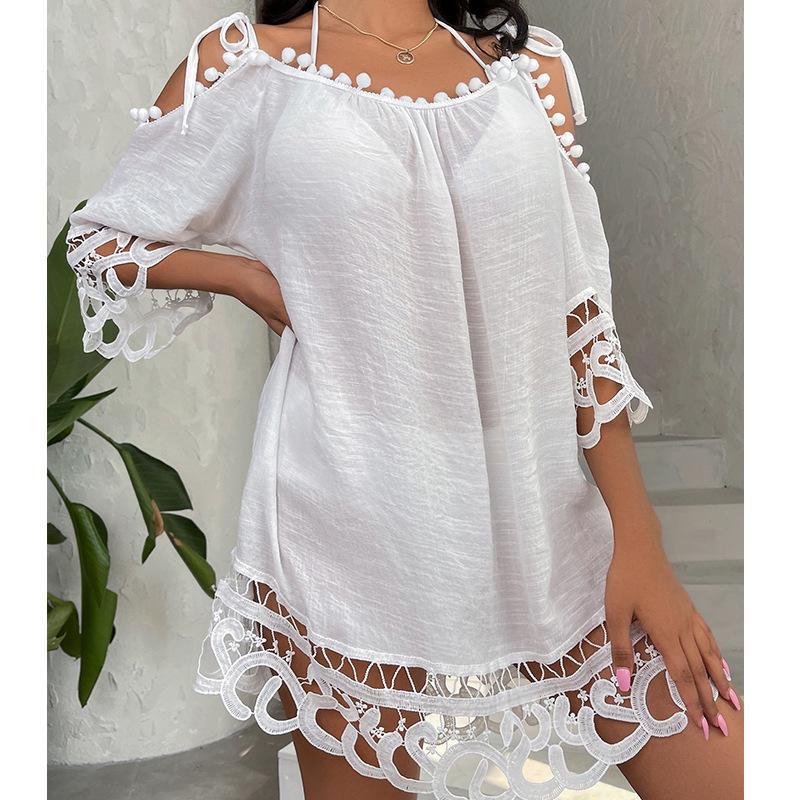 White lace dress swimsuit cover-up with cut-out sleeves and hem on a neutral background